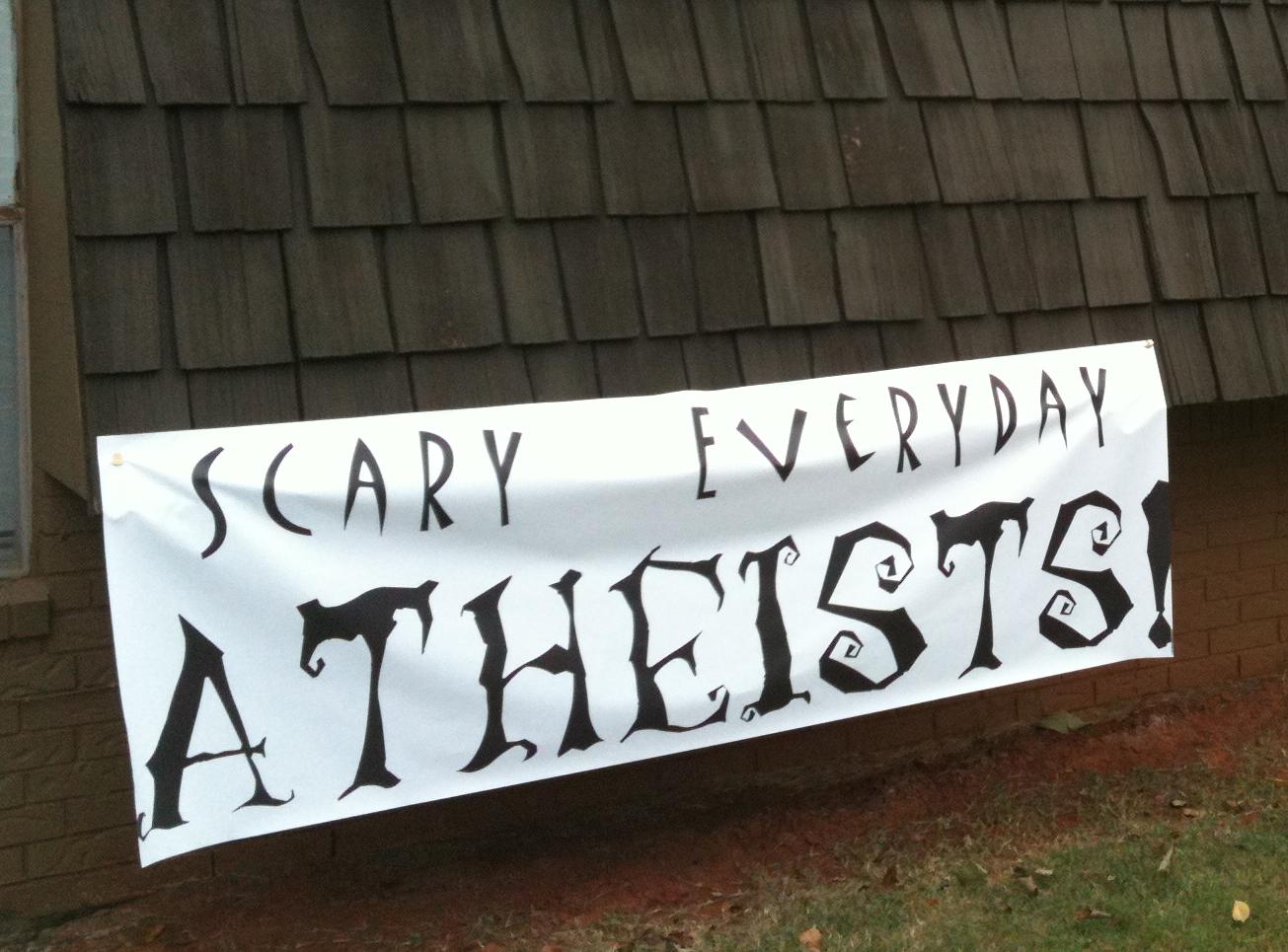 ["Scary Everyday Atheists" banner on the side of a house]