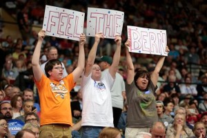 From left, Sam Brueggeman, 16, and his parents Bill and Carol, of North Freedom, Wis., lead a cheer while waiting for Democratic presidential candidate Sen. Bernie Sanders to arrive at the Veterans Memorial Coliseum at Alliant Energy Center in Madison, Wis., Wednesday, July 1, 2015. (Michael P. King/Wisconsin State Journal via AP)
