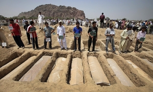 Pakistani Ahmadis bury their dead after a massacre